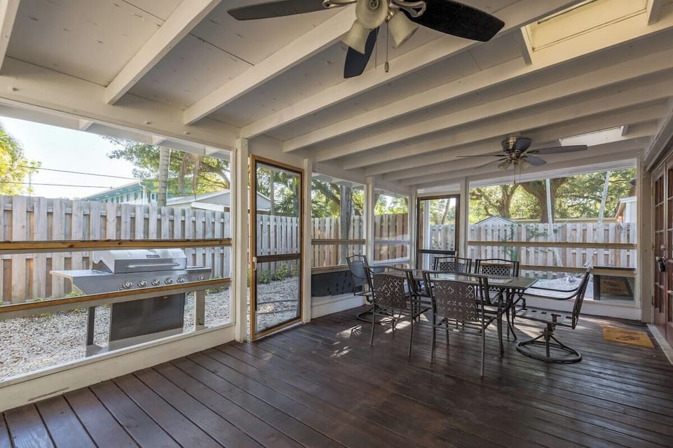 covered patio with outdoor dining and bbq