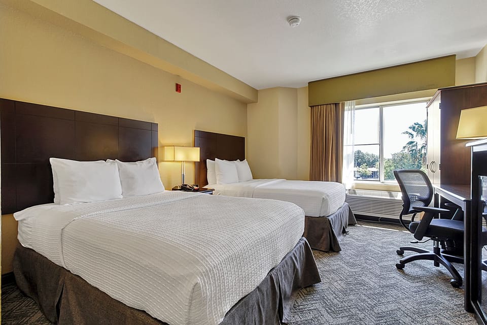 Unwind in a bright double-queen room with work desk.