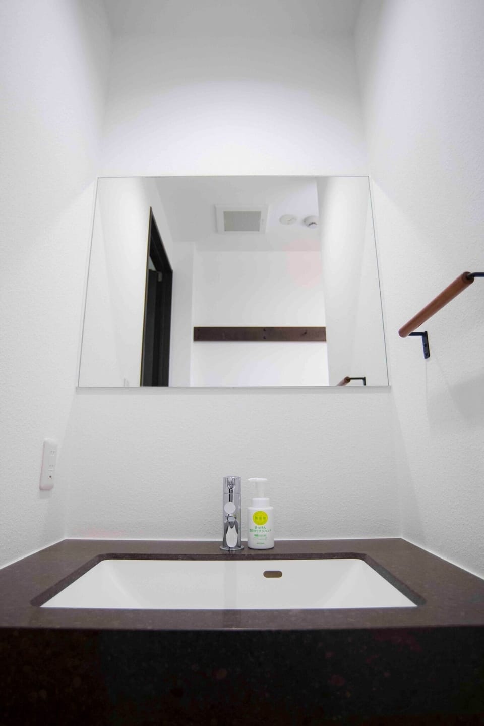 There are two washbasins with large mirrors in the room.