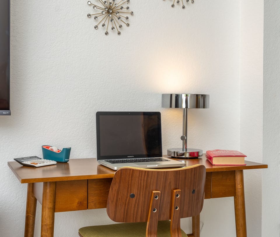 Small desk/workstation with office amenities (laptop not included).