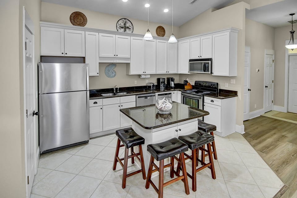 Open concept kitchen with additional seating at island for 4