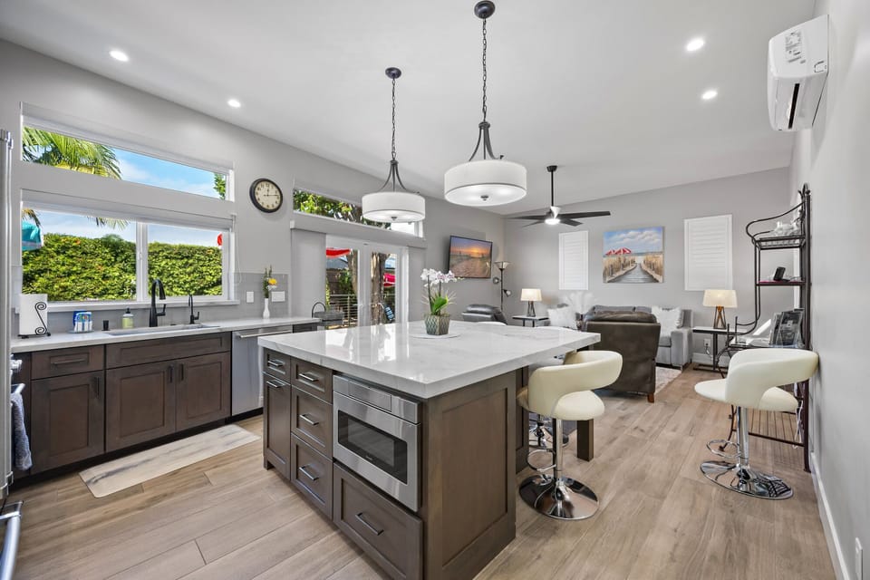 Modern kitchen with open concept, living room, overlooking the exterior lounge deck.  