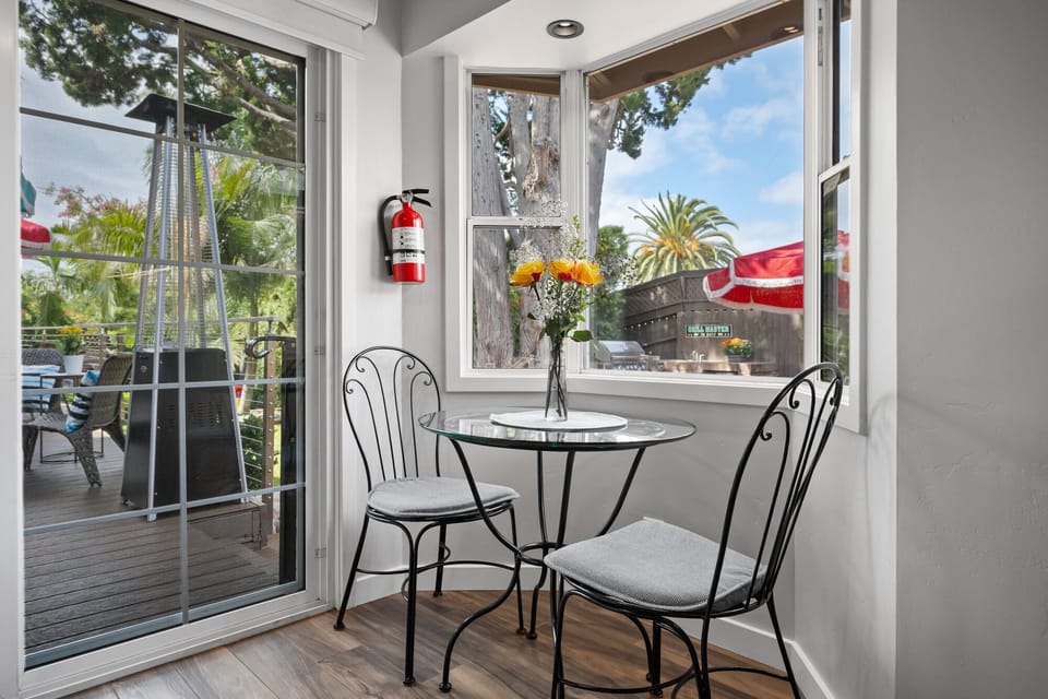 Casita nook, looks out to yard, deck between homes, and patio
