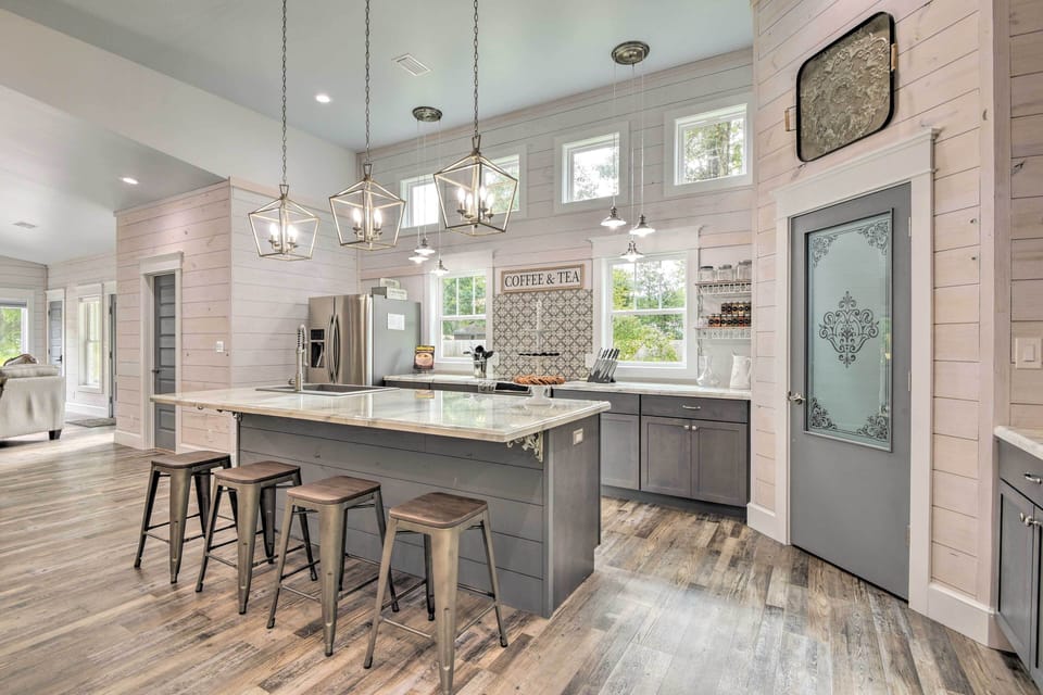 10 foot eating bar island in kitchen with glass panel pantry door. 