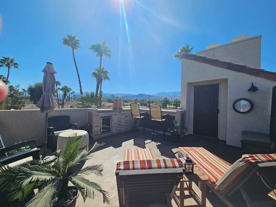Private rooftop deck with jaw dropping views, bar seating, chaises , firepit.
