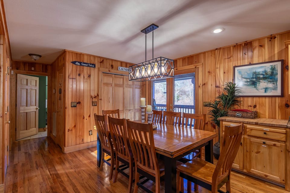 Plenty of room for the whole crew around this big farmhouse table, lit by a warm pendant light in the heart of Riverbend Retreat.