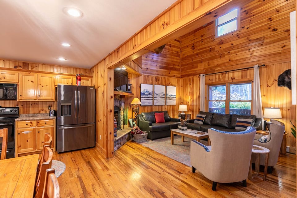Open and airy from kitchen to living room, the warm pine walls and hardwood floors set the tone for a true mountain getaway.