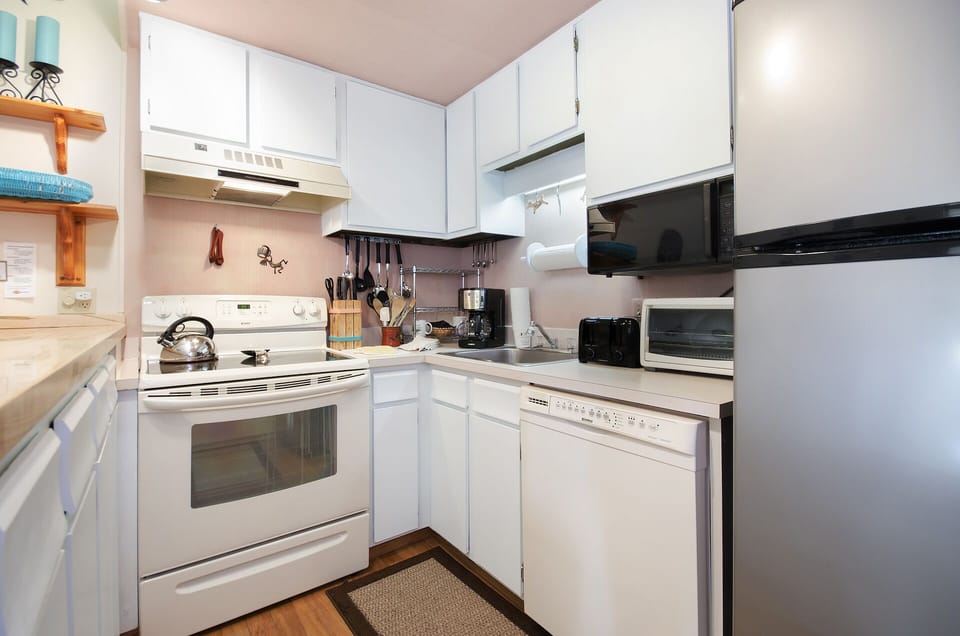 Your fully-equipped kitchen awaits with everything needed for home-cooked meals, featuring modern appliances and plenty of storage space.