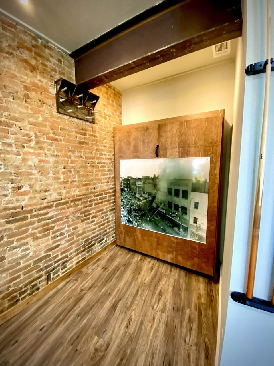 Behind this oversized photo of the great fire of Hot Springs is a Murphy Bed.