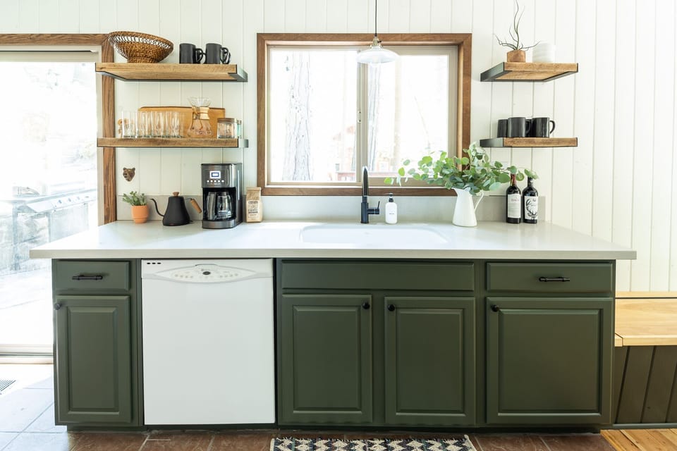 Fully stocked kitchen with dishwasher and forest views 
