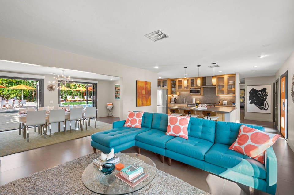 Sink into your vibrant turquoise sectional and enjoy this bright, open living space that flows seamlessly to your private pool oasis.