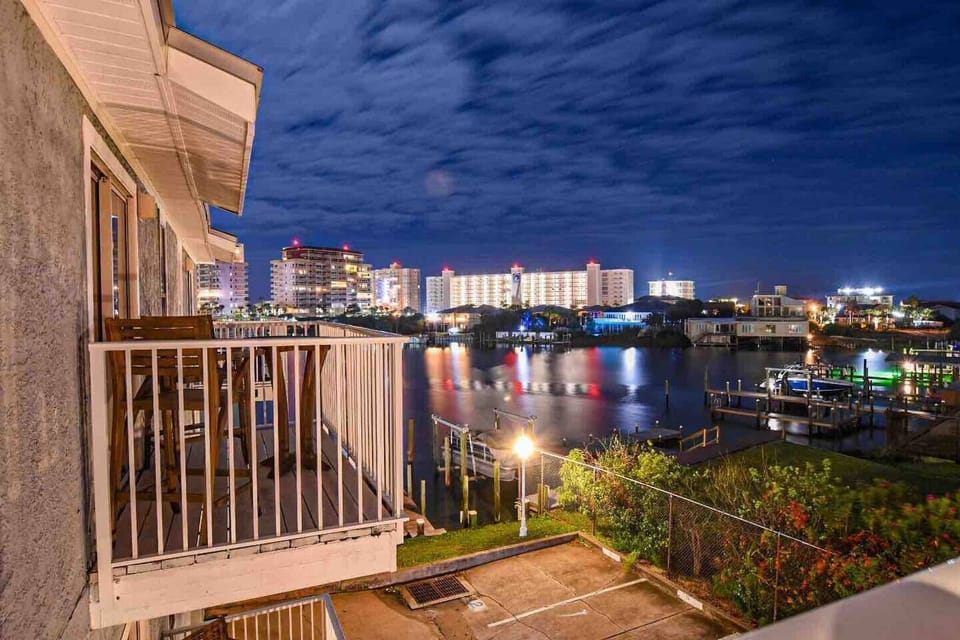 The harbor lights at night while standing on the top balcony.