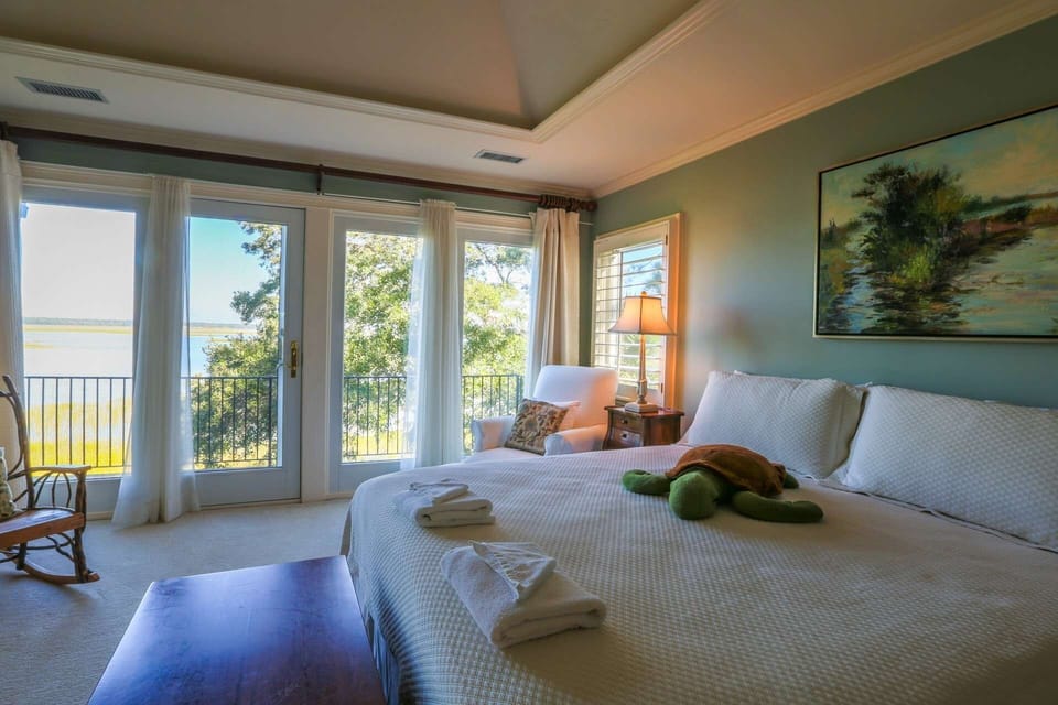 One full wall within the master bedroom features views of the tidal marsh below.