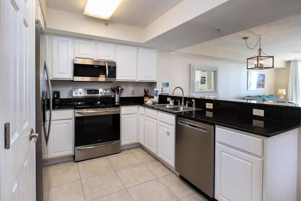 Kitchen Area - Fully equipped kitchen with ample space and state-of-the-art Stainless Steel appliances; perfect for dining in with family & friends!