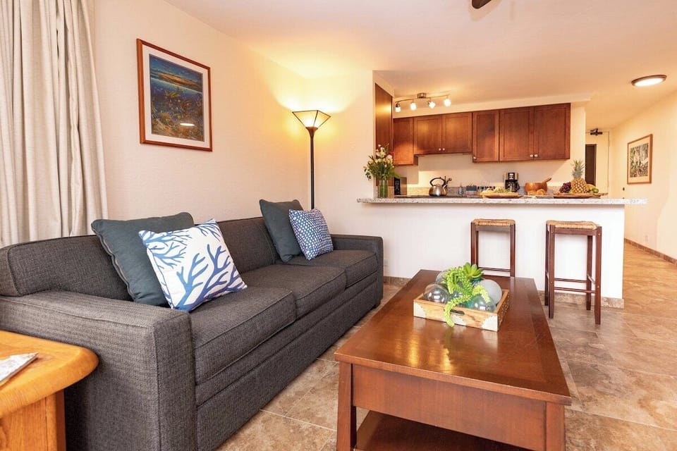 Cozy lounge area with a sleeper sofa, elegant coffee table, and warm lighting—perfect for relaxing after a day of island adventures