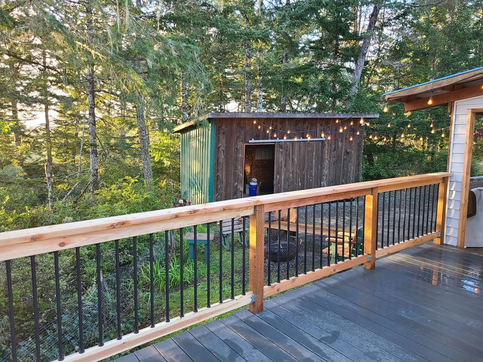 View of firepit and "bike barn" from deck. 