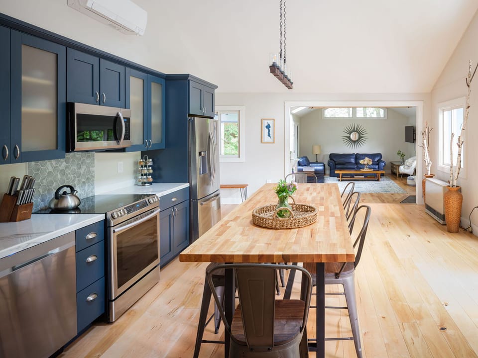The huge  kitchen has big doors to the porch deck and is open to the living room