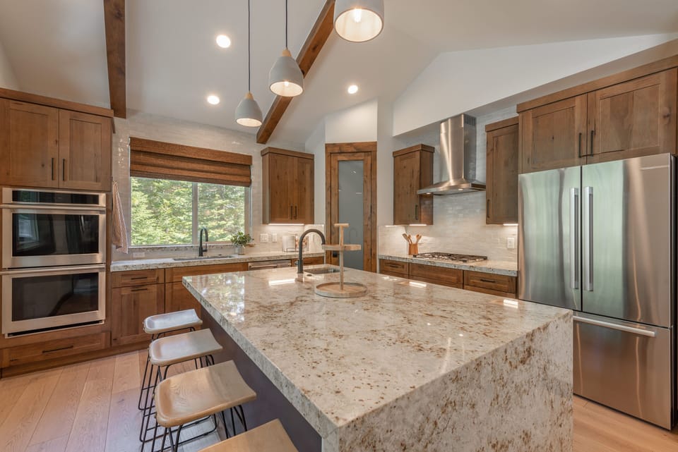 kitchen area with two sinks, one located on the island
