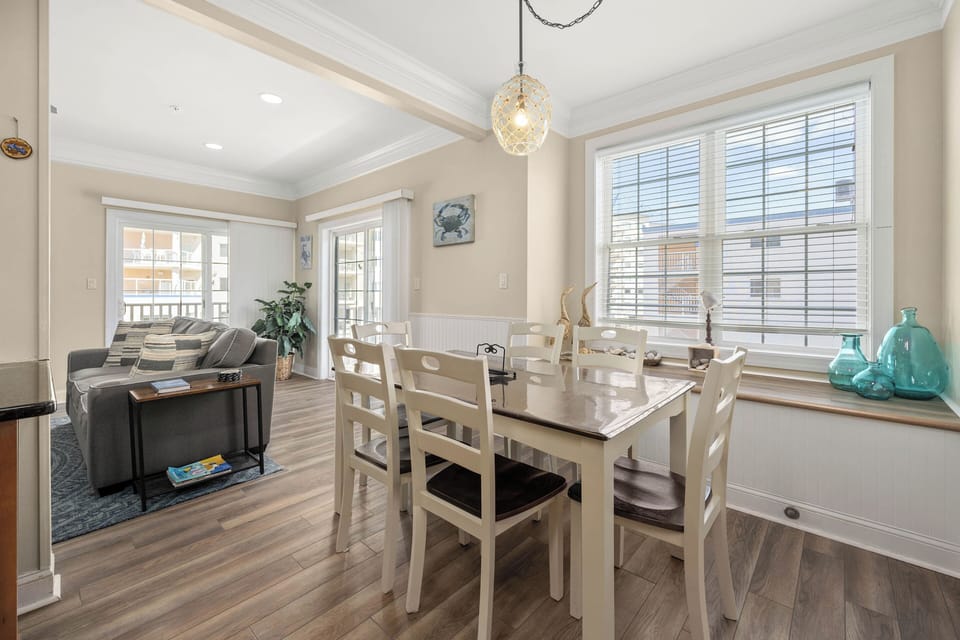Bright open dining and living space with balcony access