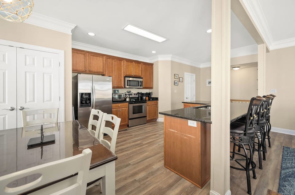 Spacious gourmet kitchen with island seating and stainless appliances