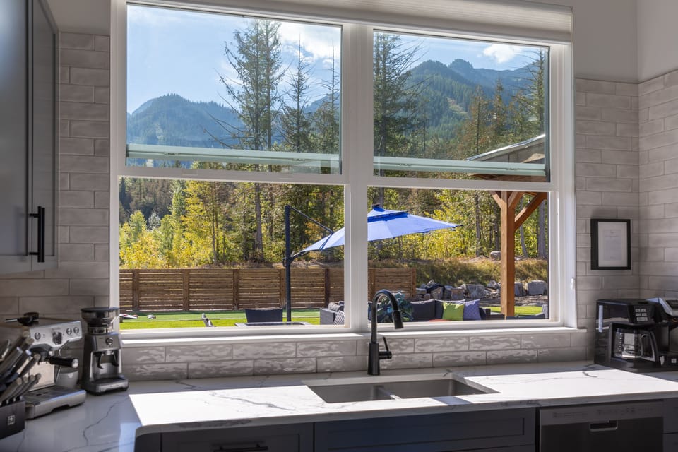 in summer, kitchen pass through windows to outdoor bar and lounge area