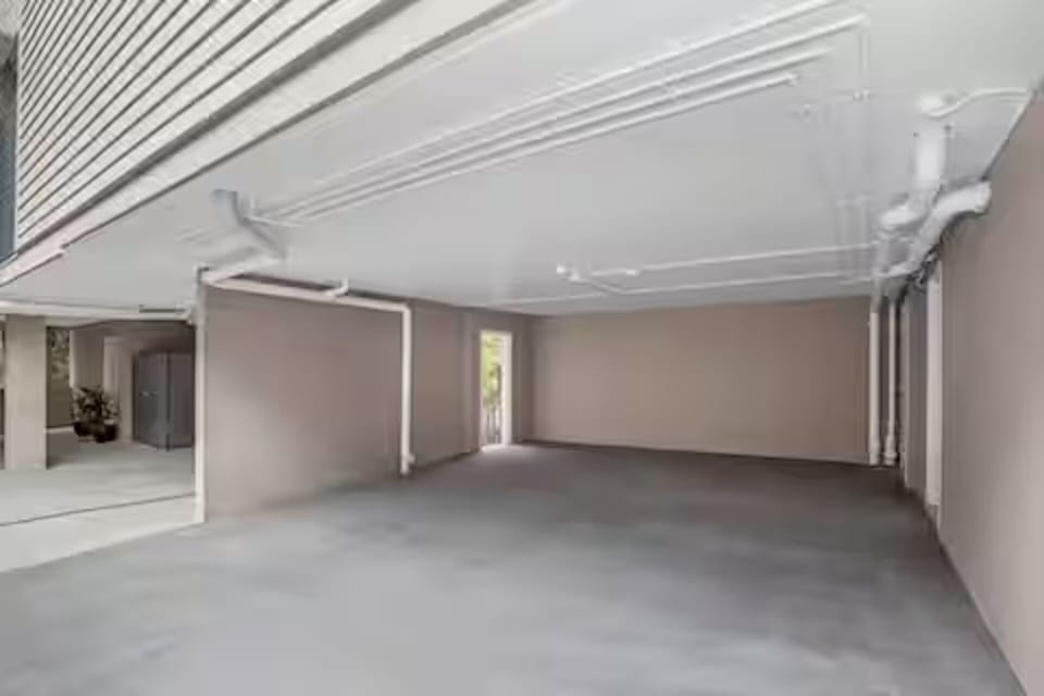 Secure undercover garage for 2 large cars with 2.4m height.