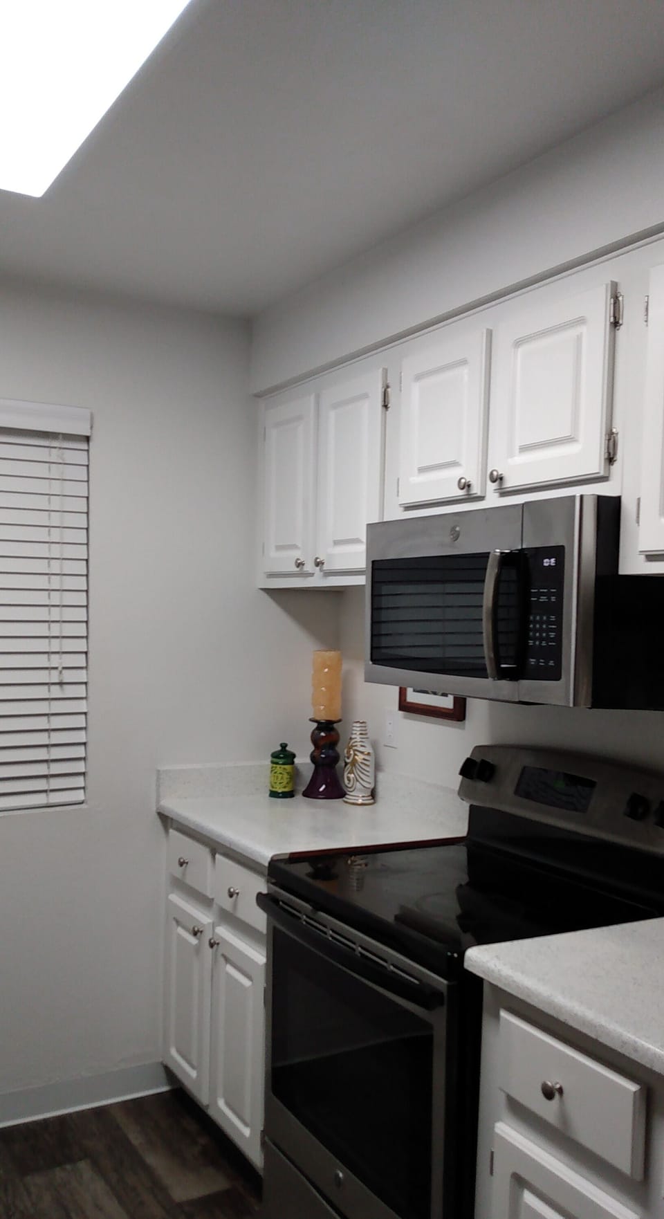 Kitchen that has all the dishes , glasses , pans , plates , bowls , toaster etc.
