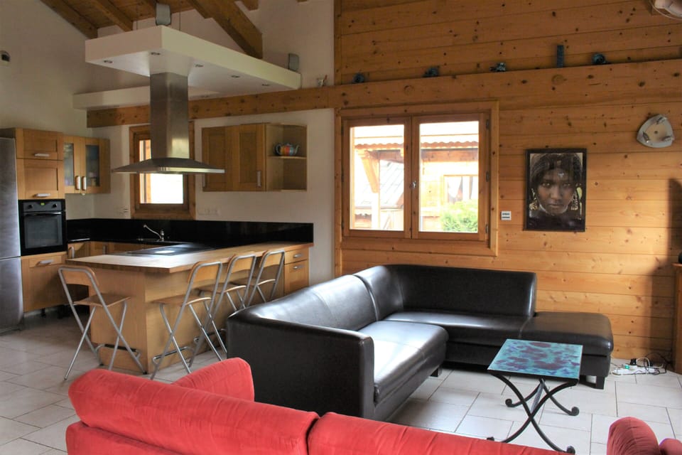 Living area and open plan kitchen with breakfast bar