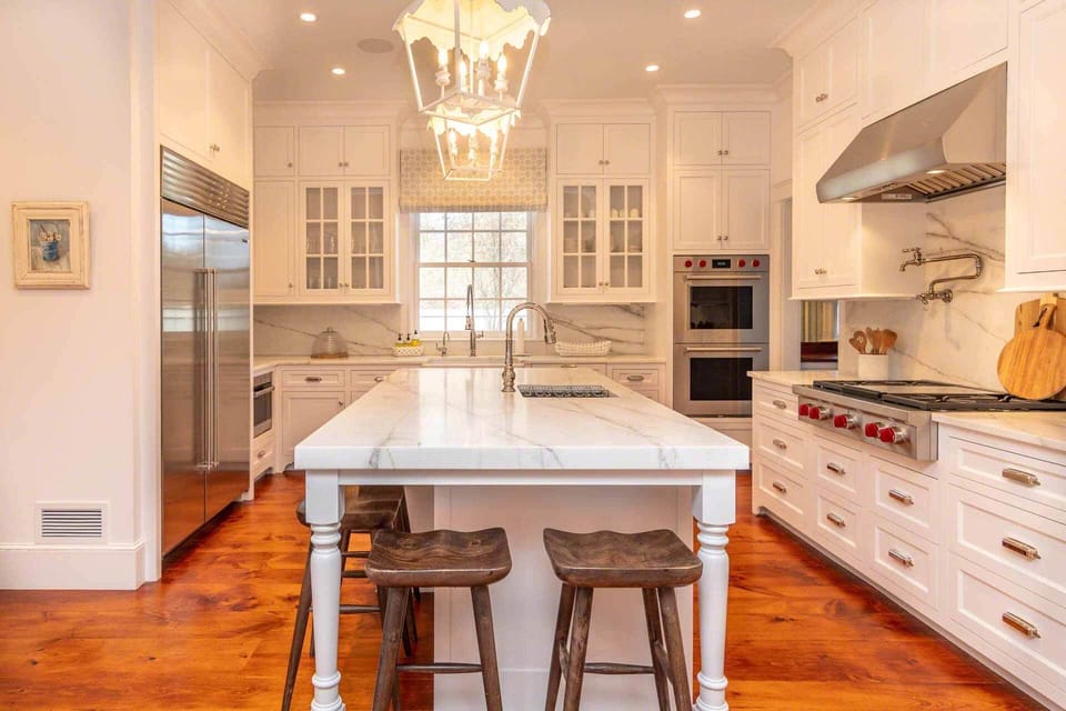 The Gourmet Chef's Kitchen Features a Large Center Island with Marble Counter, Sink and  Breakfast Bar