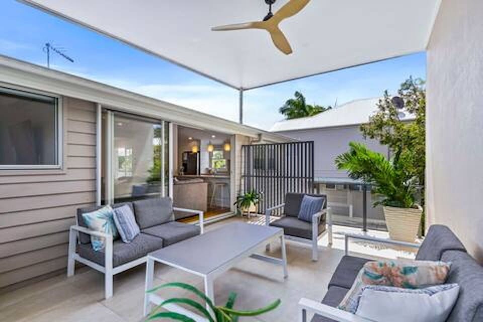 Private terrace with lounge seating, ceiling fan and BBQ space.
