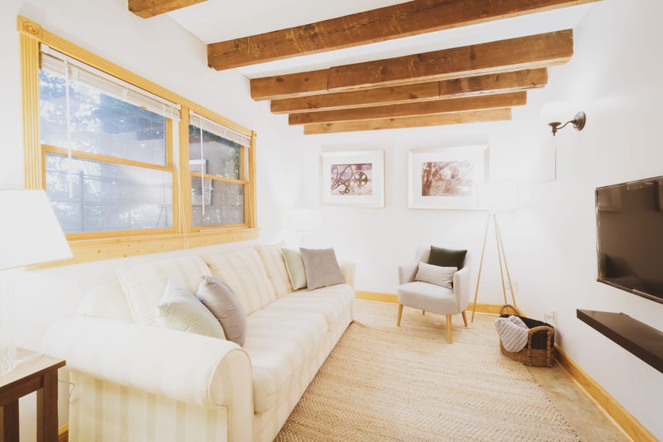 The living room has a comfortable sofa and smart TV.
