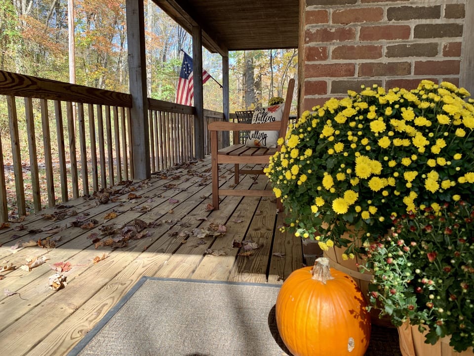 Awesome wrap-around porch overlooking the woods, fire pit and lower deck.