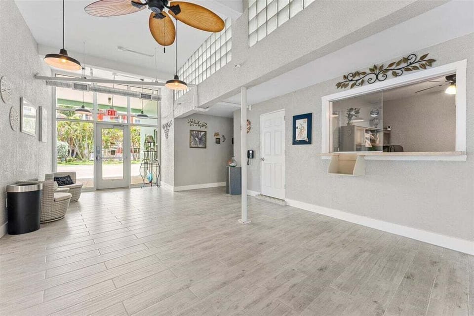 Bright, airy lobby and guest lounge with soaring ceilings and coastal décor — a welcoming introduction to your Tropic Terrace getaway.