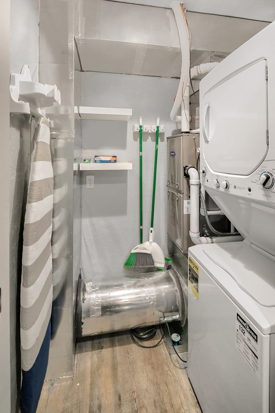 Laundry Room with Iron / Ironing Board and Washer / Dryer.  Washing Supplies inc