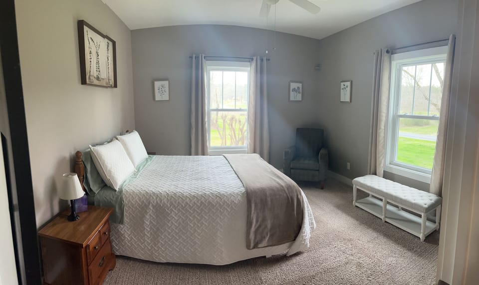 Main level guest bedroom with a queen bed. 
View from doorway. 