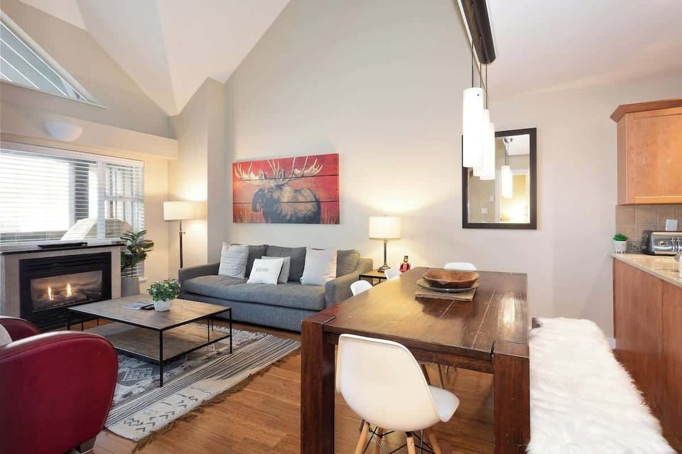 - Gather in the living area after adventure-filled days  
- Enjoy seamless flow from kitchen to lounge space  
- Fireplace glow sets the mood for cozy evenings  