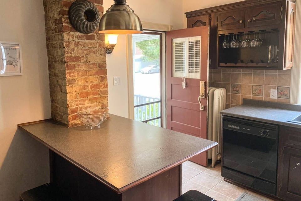 The kitchen door leads to the back patio, grill and parking pad for 2 cars.
