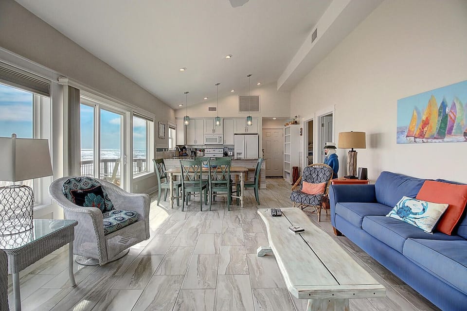 Relax in your bright, coastal living space where ocean views frame every moment through floor-to-ceiling windows.