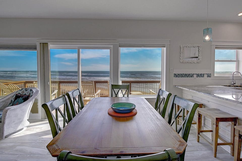 Gather around your oceanfront dining table where every meal comes with stunning sea views through floor-to-ceiling windows.