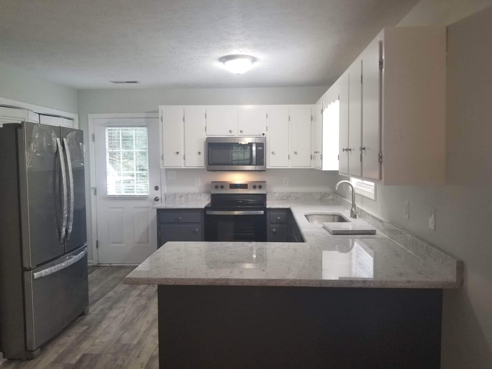 kitchen with granite countertops and new appliances