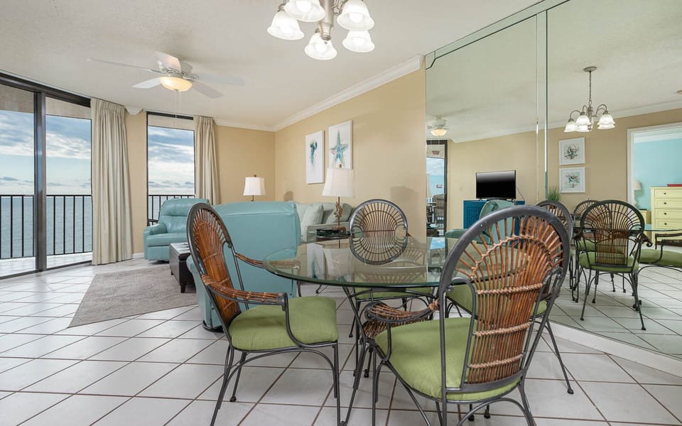 Enjoy meals at the glass dining table surrounded by comfortable seating and a view of the inviting living area