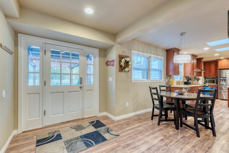 View of the back door from the driveway and the dining area