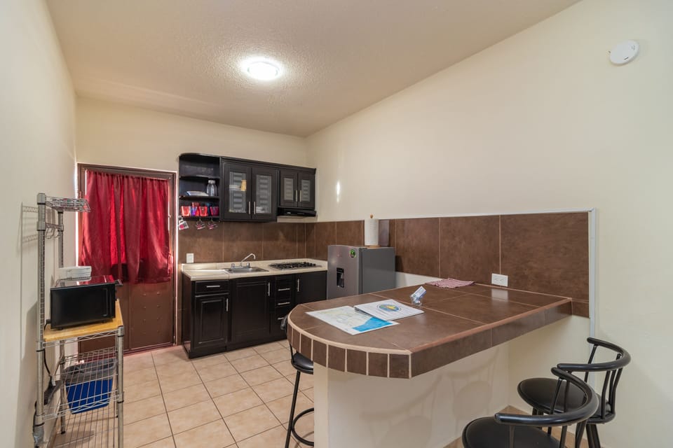 Functional kitchen with built in countertop that doubles as laptop workspace.