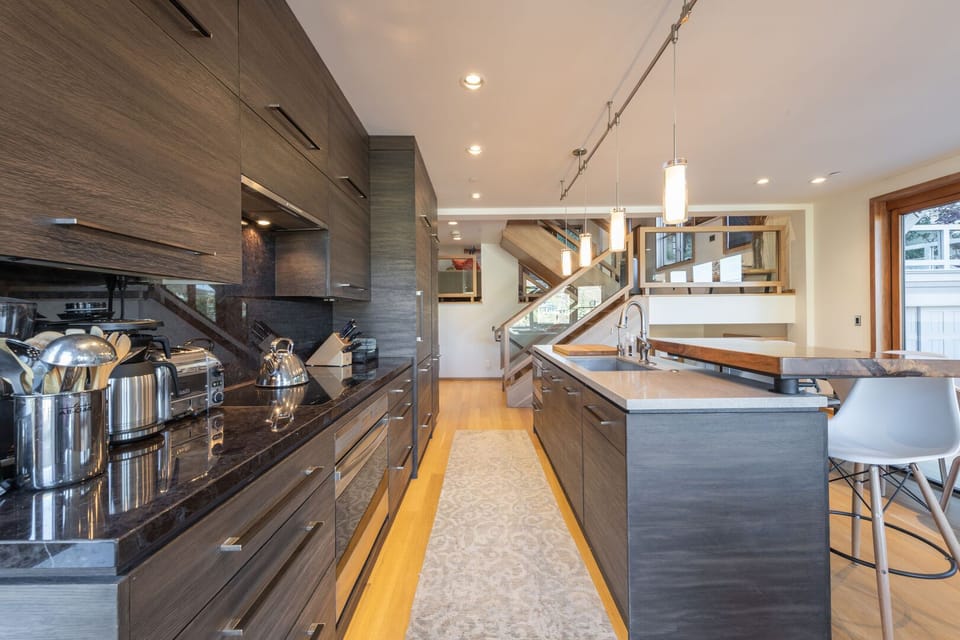 Custom kitchen features high end cabinetry and appliances with a large center island