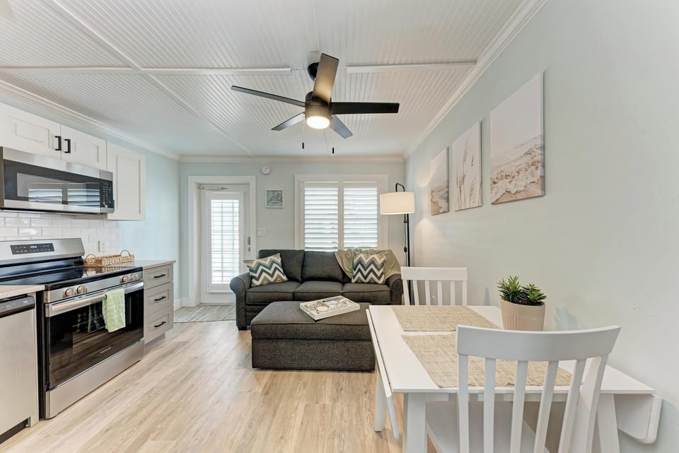 Open living and dining area with comfortable sofa, dining table, and chairs