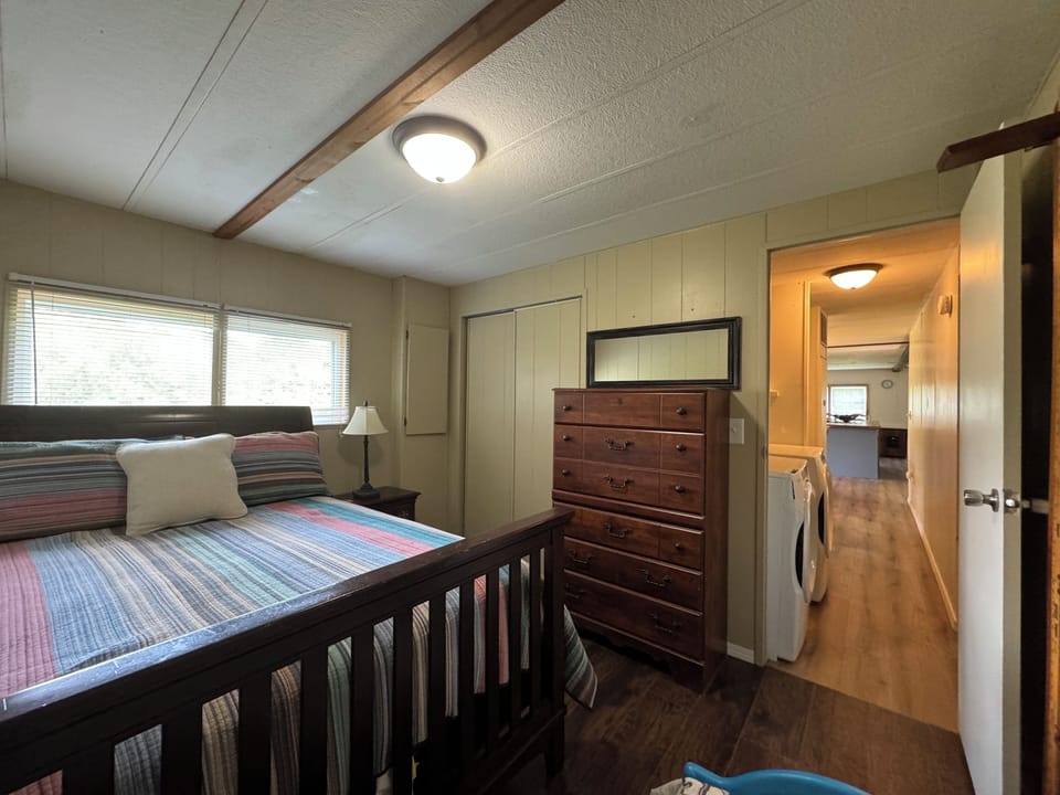 Third bedroom with full size bed and toddler bed.  View into hallway.