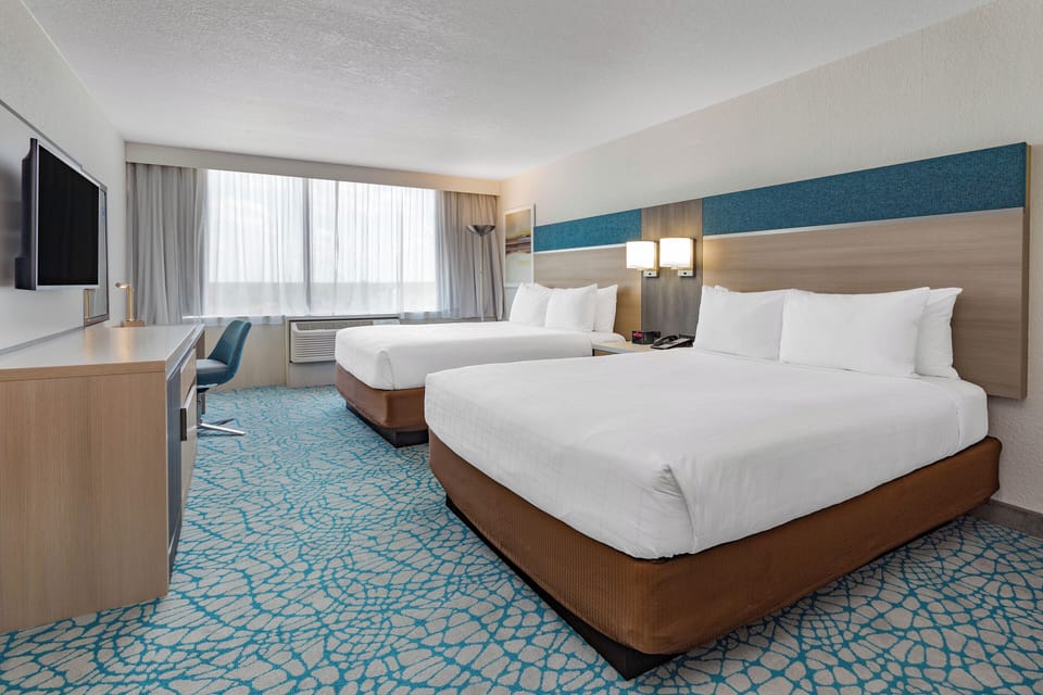 Unwind in bright comfort with two plush beds and sunshine.