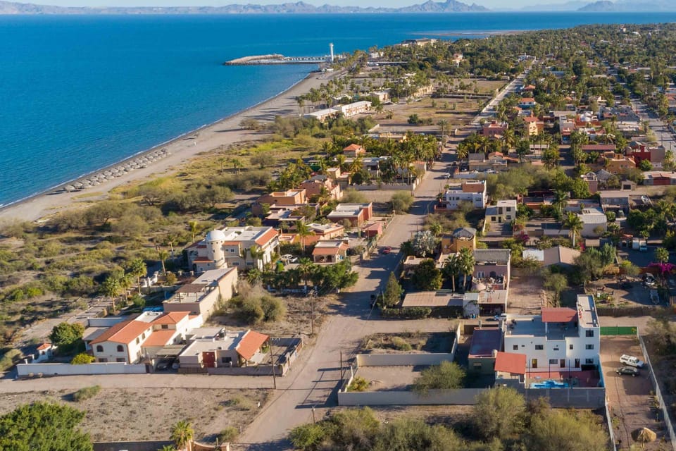 Aerial pic shows our apt bldg lower right; walk along beach to Marina lighthouse