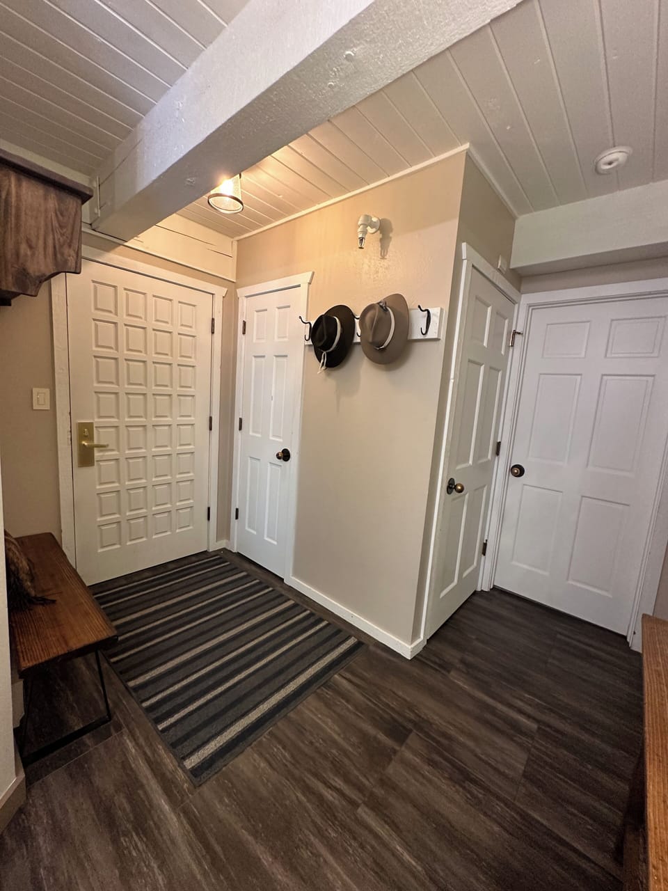 Entryway with hooks for coats and cubbies for ski gear.