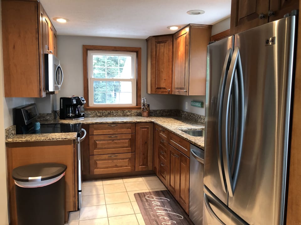 K-cup coffeepot coffee station, silverware, dishes, pots/pans. 
